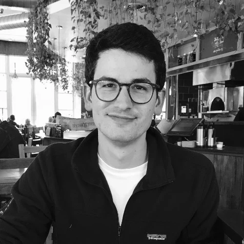 Black and white photo of Jacob Simon at a café